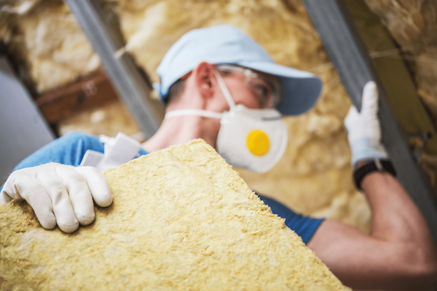 Man installing house insulation